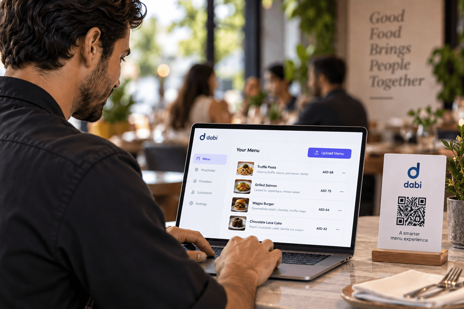 Restaurant owner reviewing the menu on a laptop